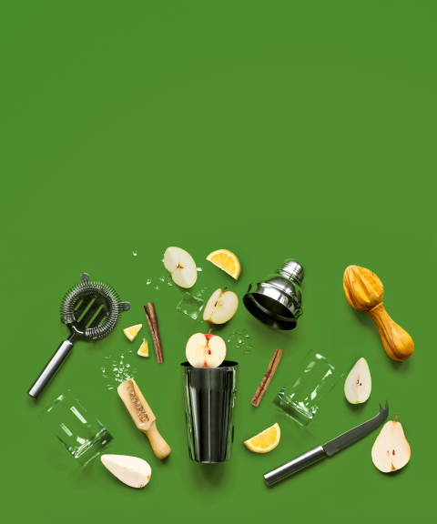 Metal shaker, strainer, ice, a glass and scoop, cinnamon sticks, and pear and apple slices for Confetti's BYO Fall Online Mixology Class