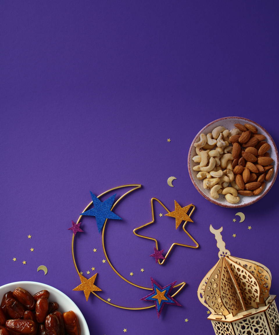 Purple background with moon and stars, small bowls of food, and a small building