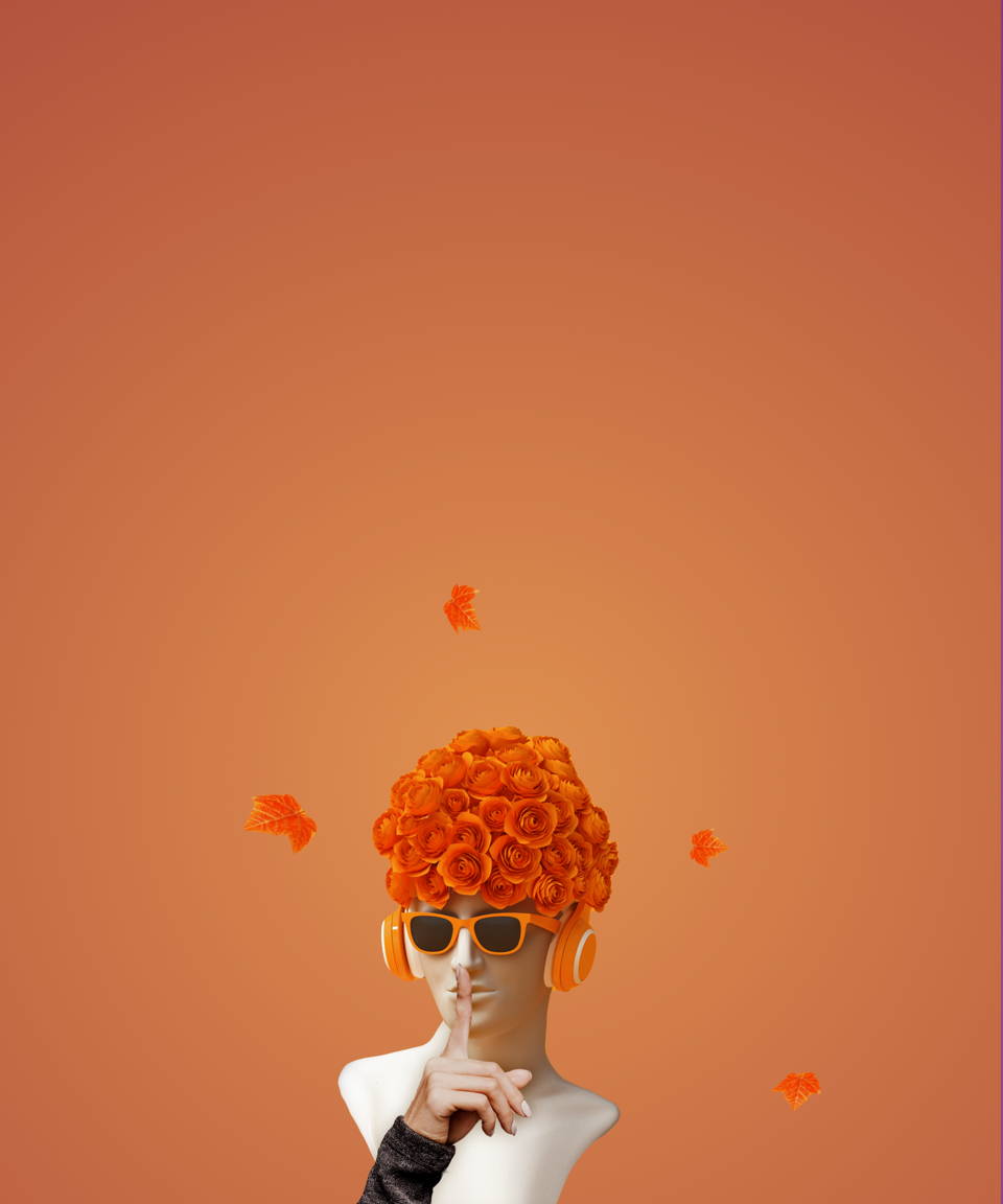 A statue head wearing orange headphones with autumnal flowers on its head with a finger in front of it's mouth in a 'silencing' gesture for Confetti's Virtual Fall Taboo