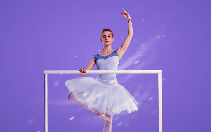 A winter ballerina in relevé at a ballet bar for Confetti's Team Building Dance Class (Preview)