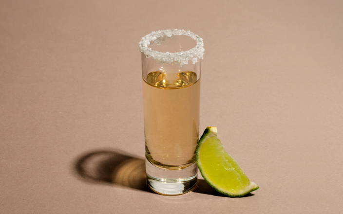 A shot of tequila with a salt rim and a lime wedge for Confetti's Virtual BYO Tequila Tasting Events