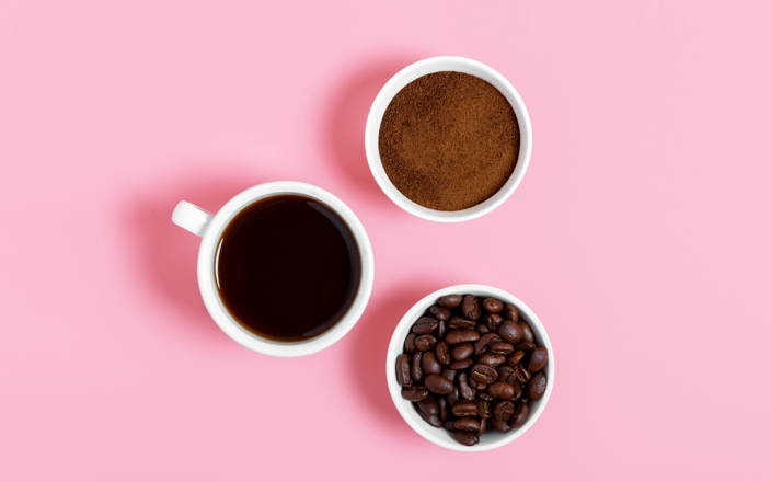 A birds eye view of two cups of coffee and a bowl of coffee beans for Confetti's Virtual Coffee Tasting Class