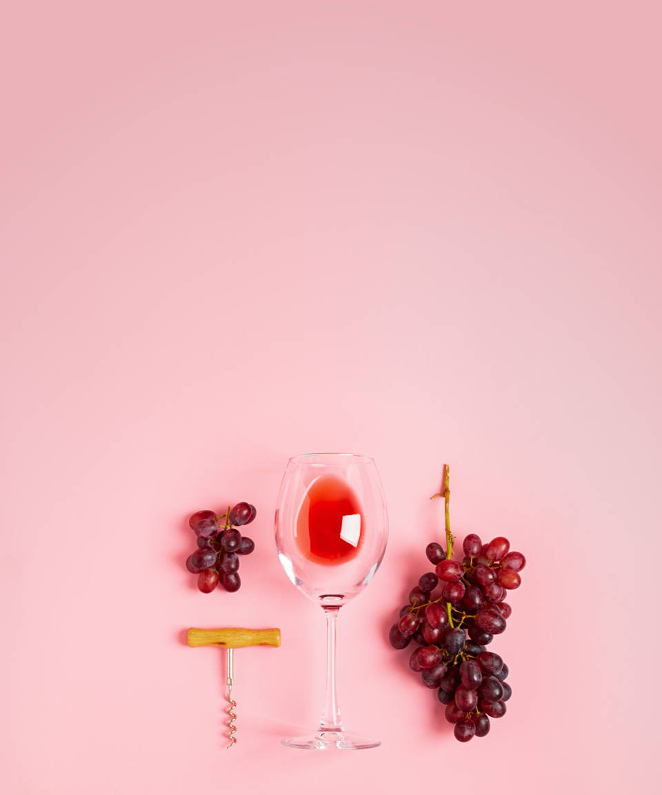 Grapes, a wine glass, and a wine opener for Confetti's Virtual Wine Tasting