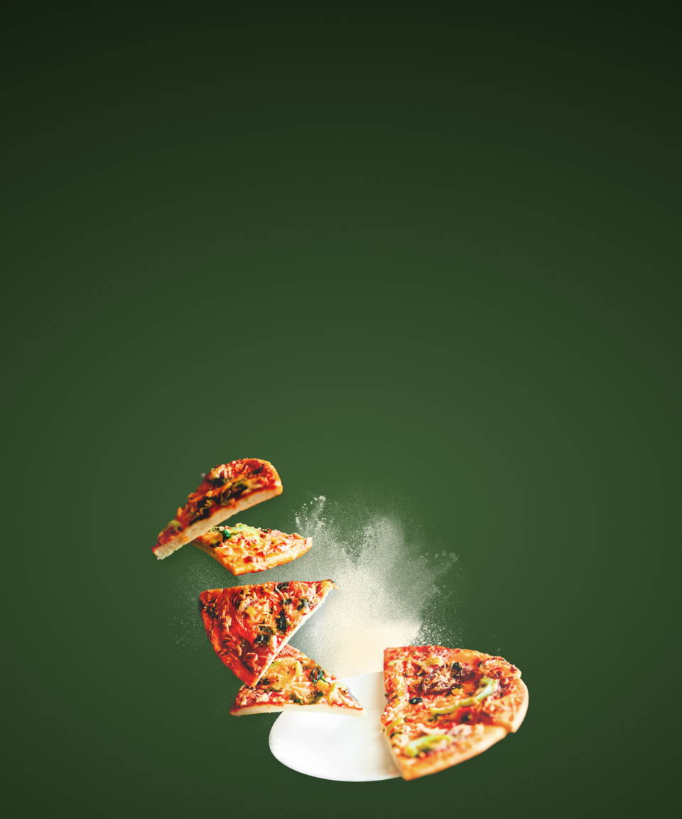 A full pizza with half of the slices levitating off the plate for Confetti's Virtual BYO Pizza Making Class