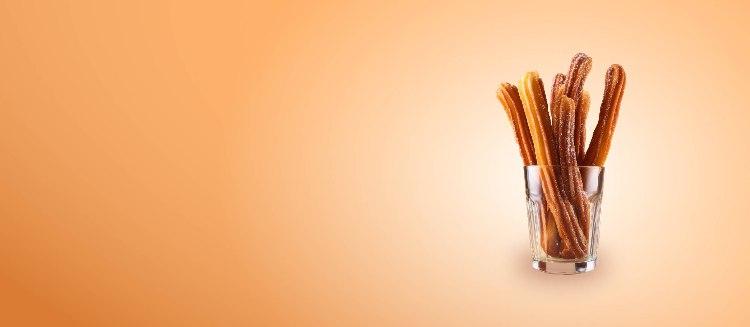 Sugar and cinnamon coated deep fried churros in a glass cup (large)