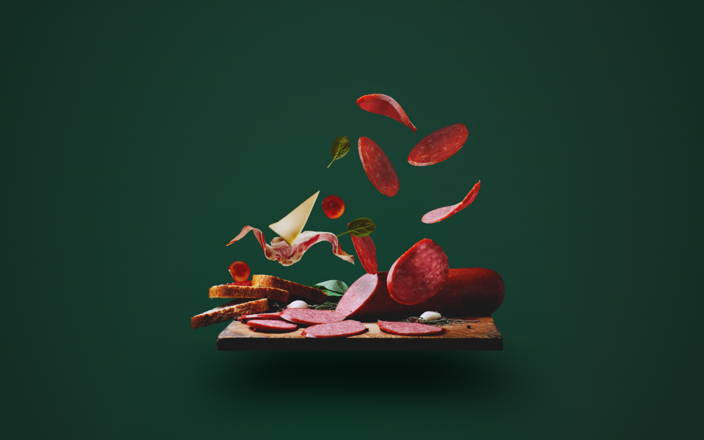 Charcuterie board with flying sliced meats and cheese (preview)