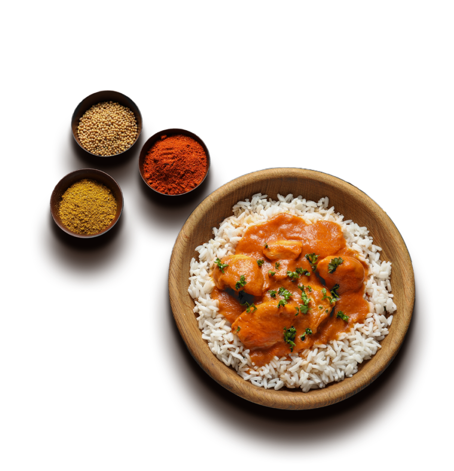 Thai chicken curry with rice and bowls of spices