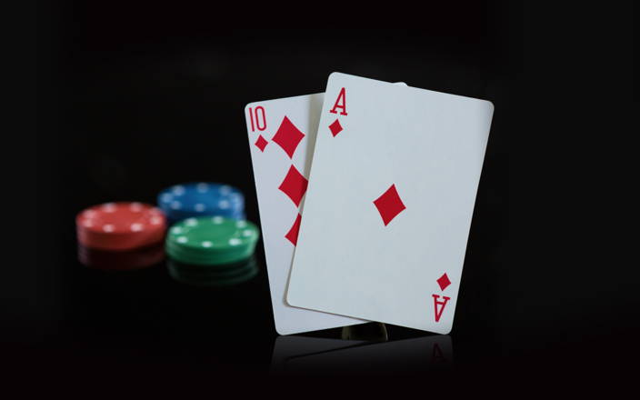 three stacks of poker chips and two cards hitting blackjack for Confetti's Virtual Corporate Casino Night 