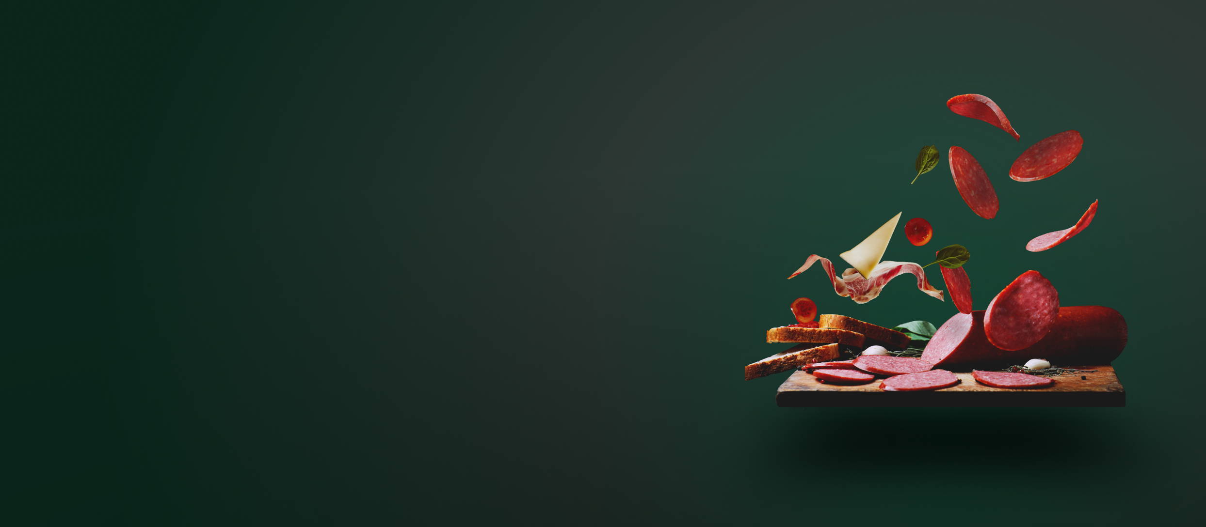 A charcuterie board with some of the meats and cheeses levitating above for Confetti's Virtual Charcuterie Board Class