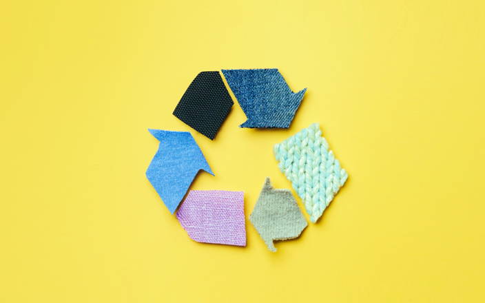A recycling logo made of colorful scraps of various fabric for Confetti's Virtual Zero Waste Workshop 