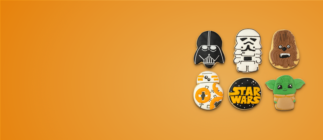 Cookies iced like different characters from the Star Wars franchise for Confetti's Virtual Star Wars Sugar Cookie Decorating Class