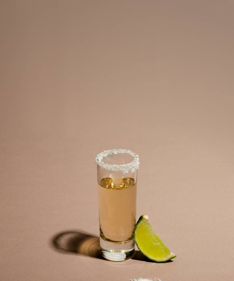 A shot of tequila with a salt rim and a lime wedge for Confetti's Virtual BYO Tequila Tasting 