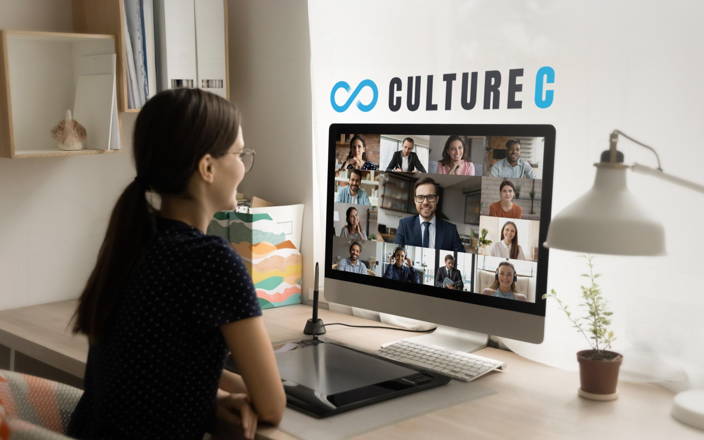 Woman sitting at her computer, on Zoom, with words above that say "Culture C"