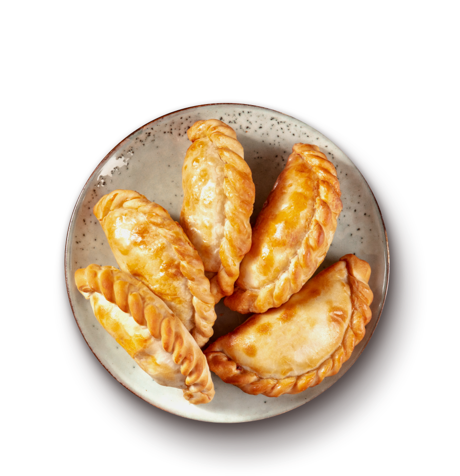 Baked empanadas on a porcelain plate