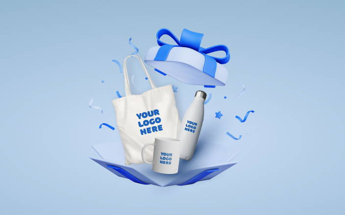 Tote bag, mug, and water bottle with 'Your Logo Here' in an opened gift box (preview)