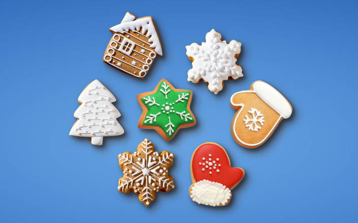A plate full of various holiday themed cookies for Confetti's Virtual Holiday Cookie Decorating Class