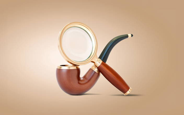 Magnifying glass propped against wooden pipe (preview)