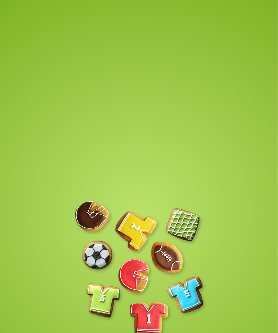 Various colorful sports theme cookies in shapes like helmets, jerseys, balls, and more for Confetti's Virtual Sports Cookie Decorating