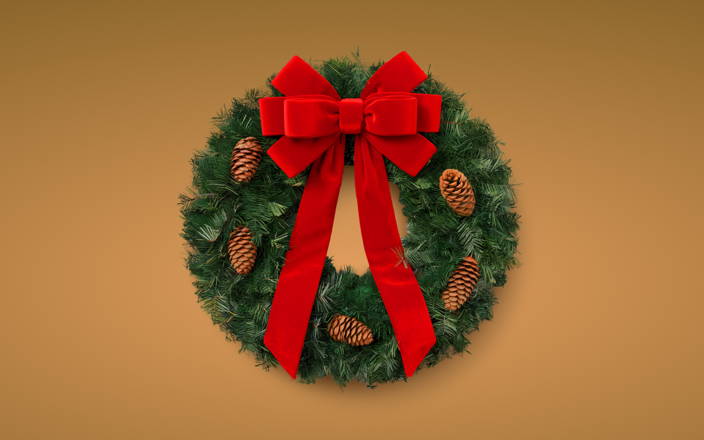 A holiday wreath with pinecones and a red bow 