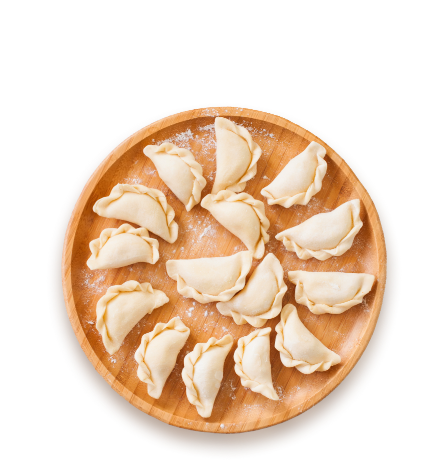 Unbaked hand pies on a wooden plate