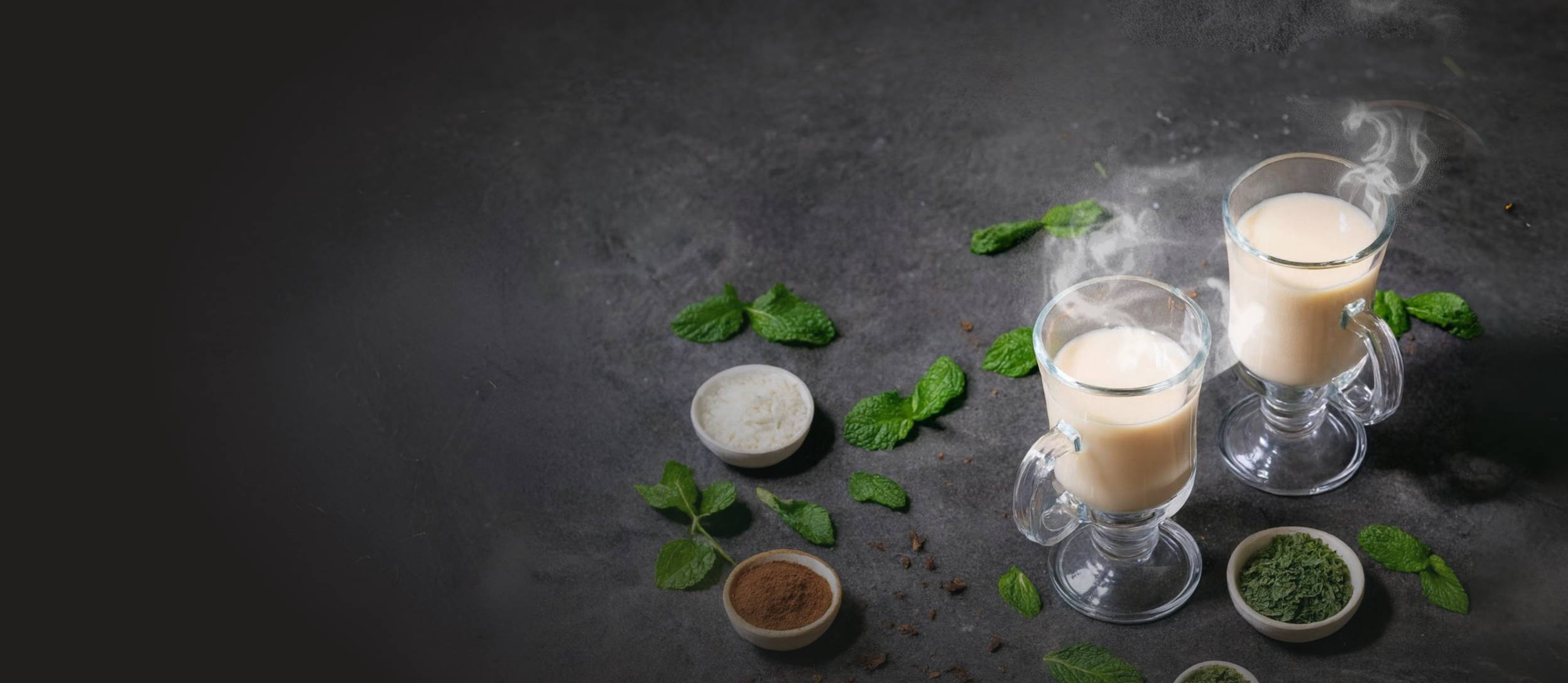 Hot drinks in a clear mug with cocoa, peppermint and other ingredients.
