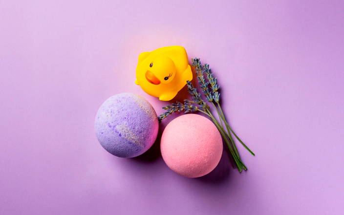 Pink and purple bath bombs, lavender, and rubber duck (preview)