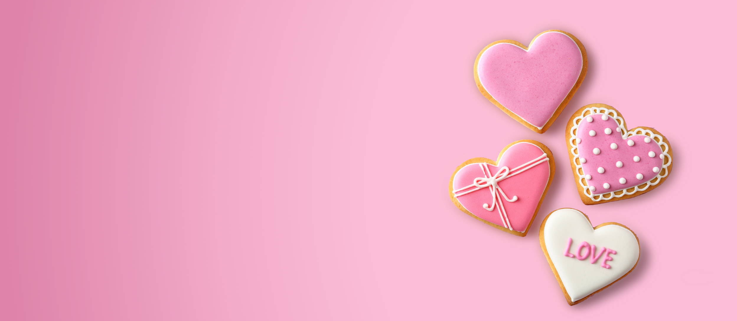Heart shaped cookies iced and decorated for Confetti's Virtual Valentine's Day Cookie Decorating Classes Online