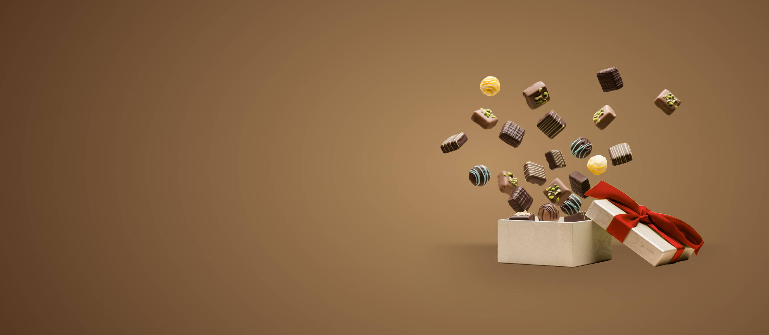 chocolates jumping out of a gift box for Confetti's Holiday Virtual Chocolate Tasting