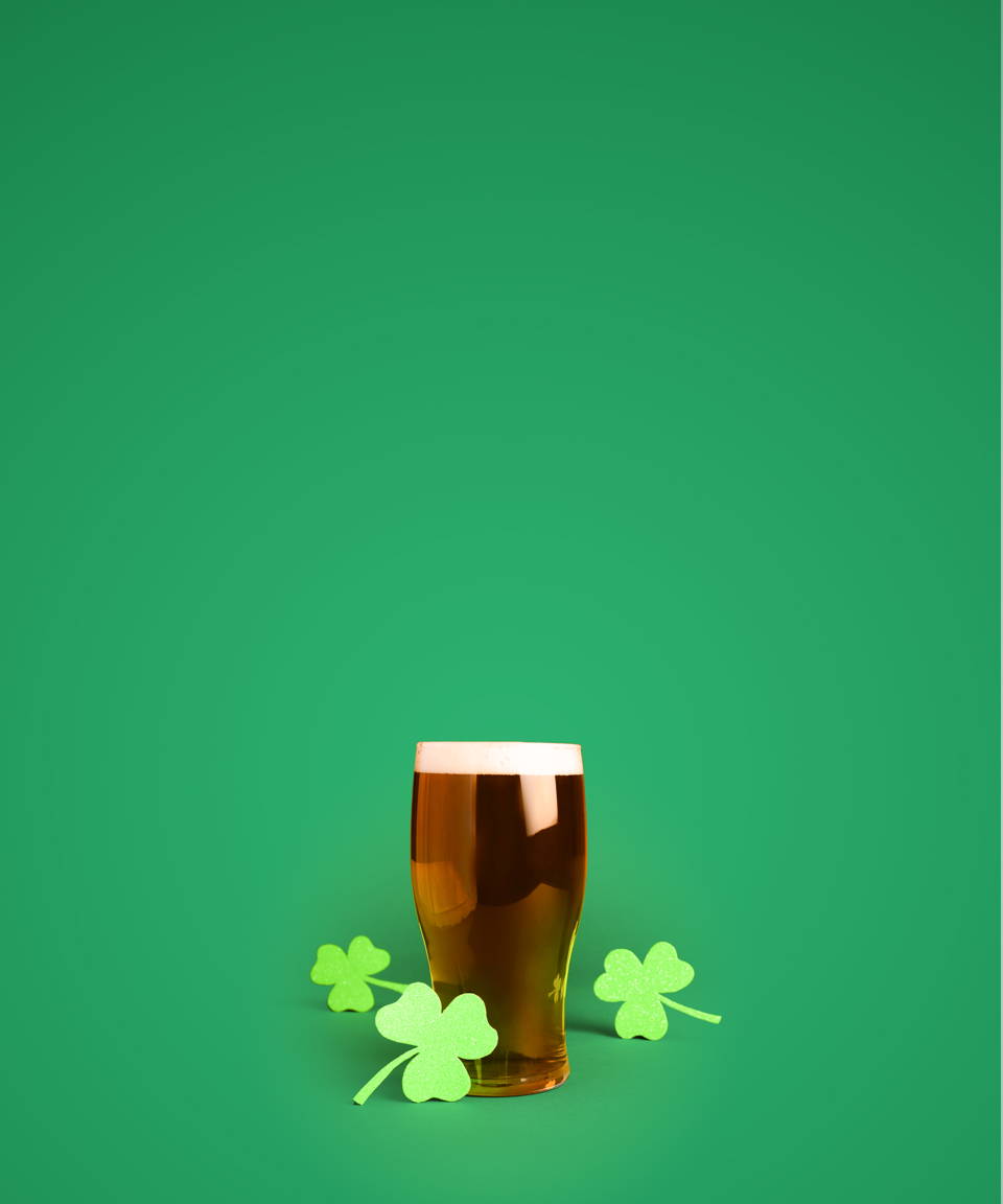 Paper shamrocks around a pint of beer for Confetti's Virtual Irish Beer Tasting