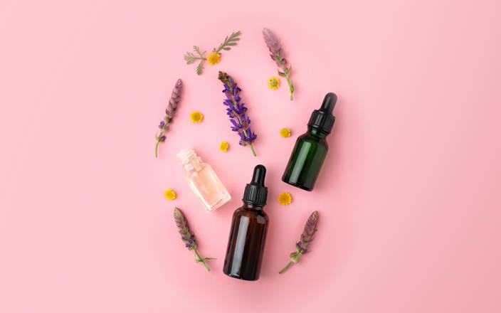 Various lavender branches and flower blossoms around dropper bottles for Confetti's Virtual Aromatherapy Classes