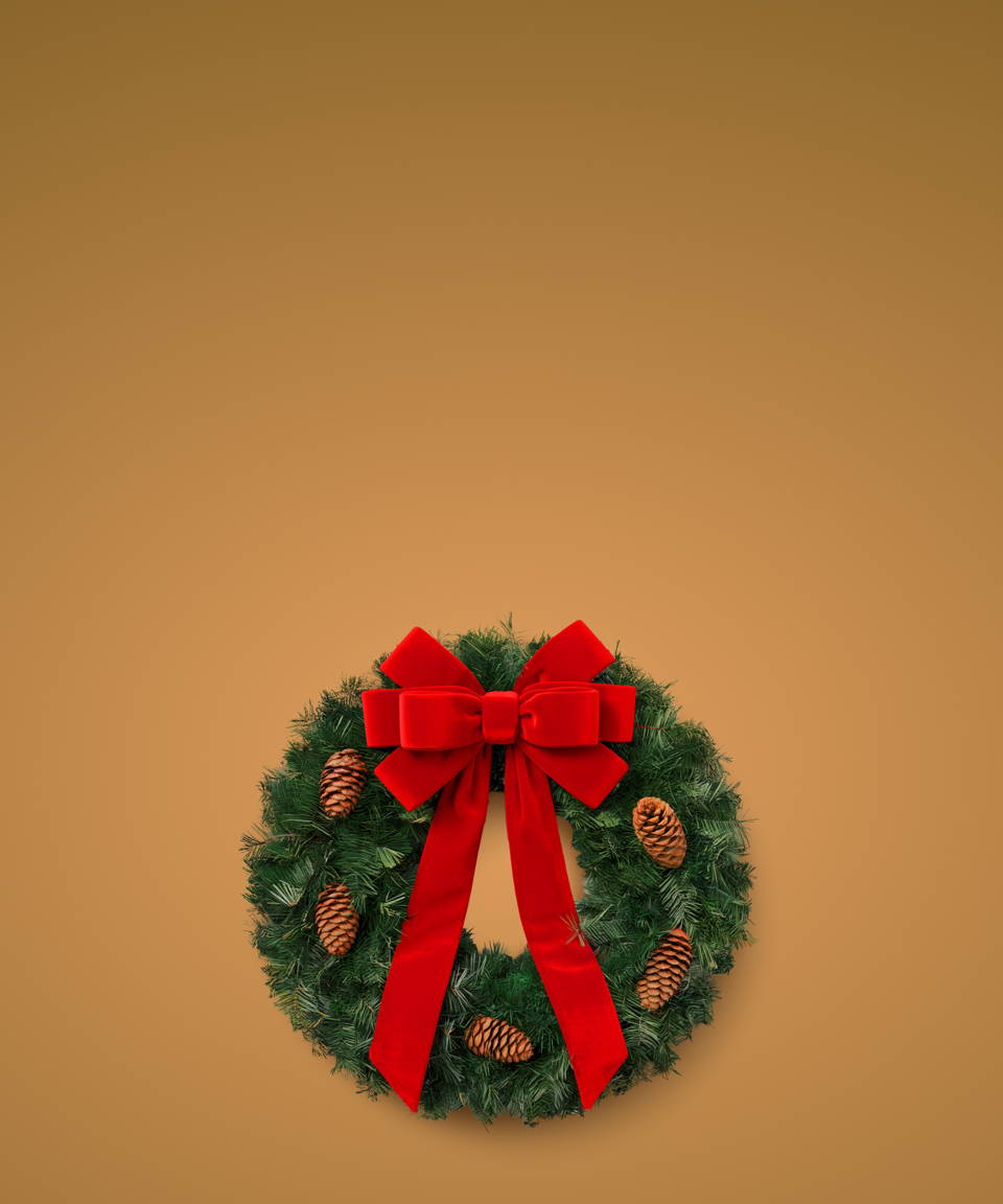 A live greenery wreath with pinecones and a red bow (small)