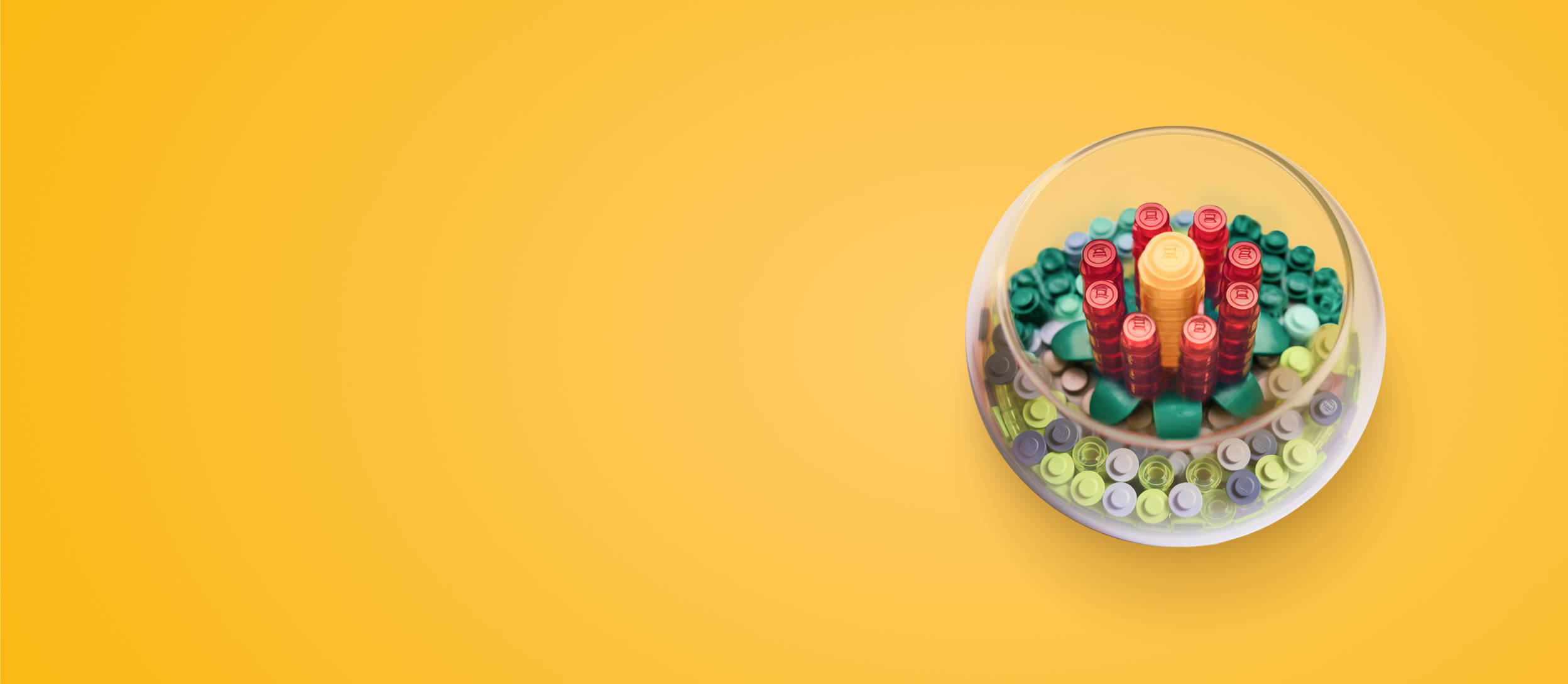 A glass terrarium including a flower made of toy bricks (small)