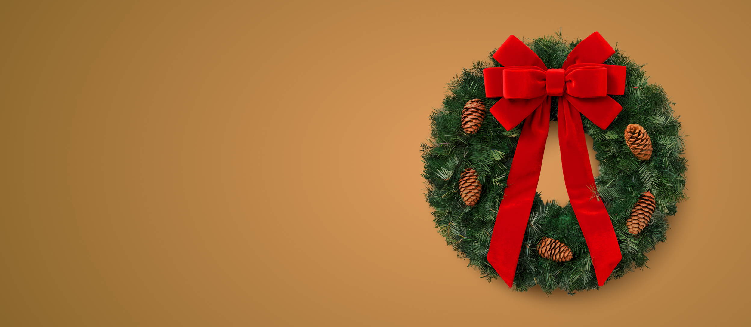 A live greenery wreath with pinecones and a red bow (main)