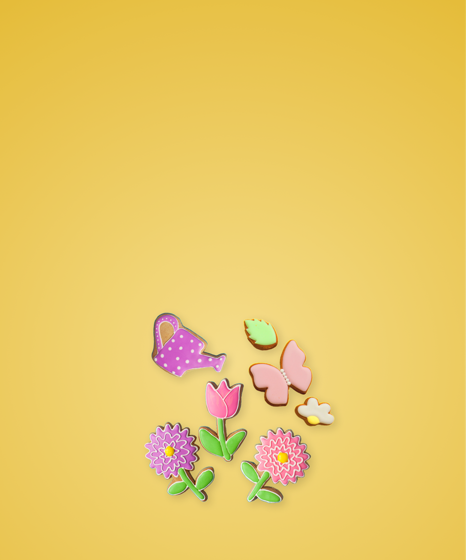 Spring cookies shaped like flowers, butterflies, and a watering pail for Confetti's Virtual Spring Cookie Decorating