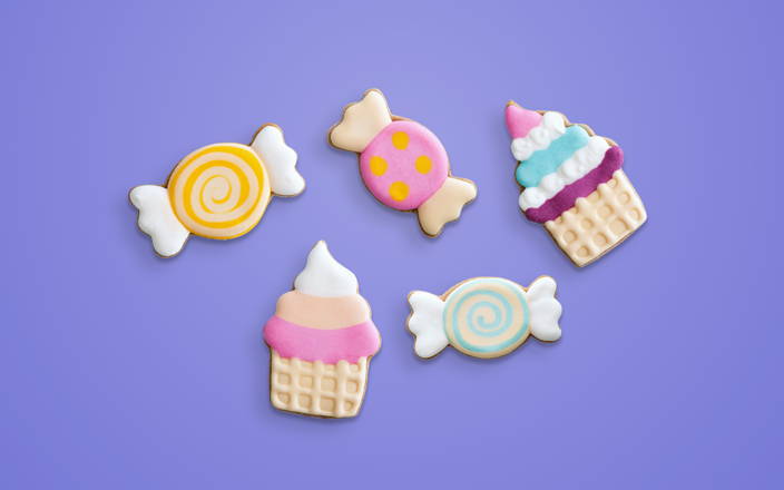 Colorful, iced cookies in cupcakes and candy shapes for Confetti's Virtual Cookie Decorating Class