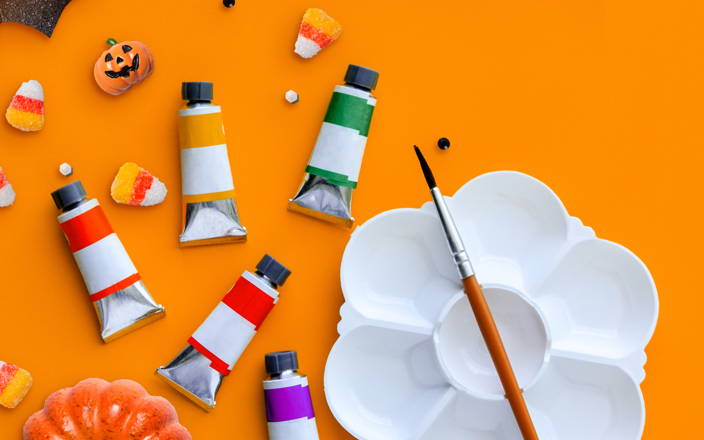 Candy corn, mini pumpkins, paints, and an empty paint tray for Confetti's Virtual At Home Painting Class