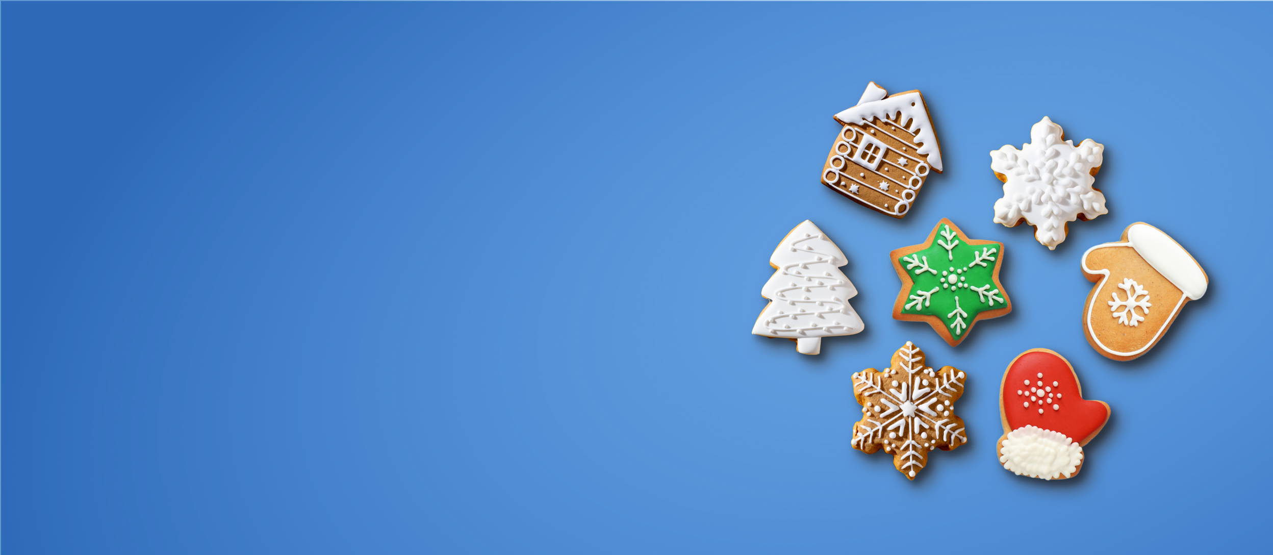 A plate full of various holiday themed cookies for Confetti's Virtual Holiday Cookie Decorating Class